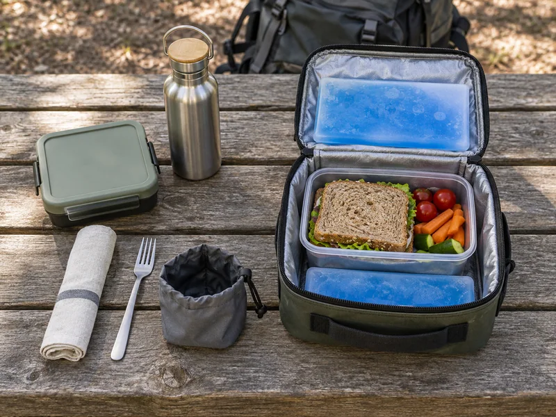 A lunch container, water bottle, napkin and small waste pouch.