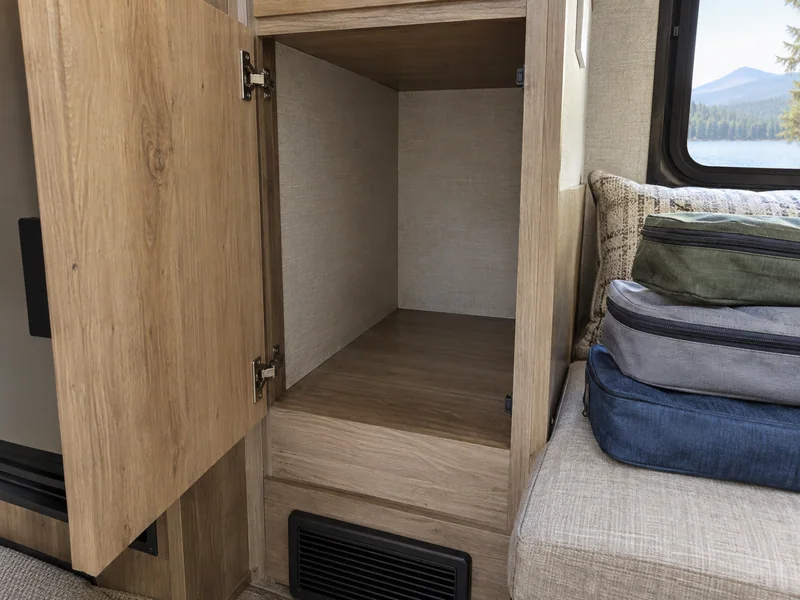Accessible RV cabinet corner with dry clothing pouches set aside for inspection